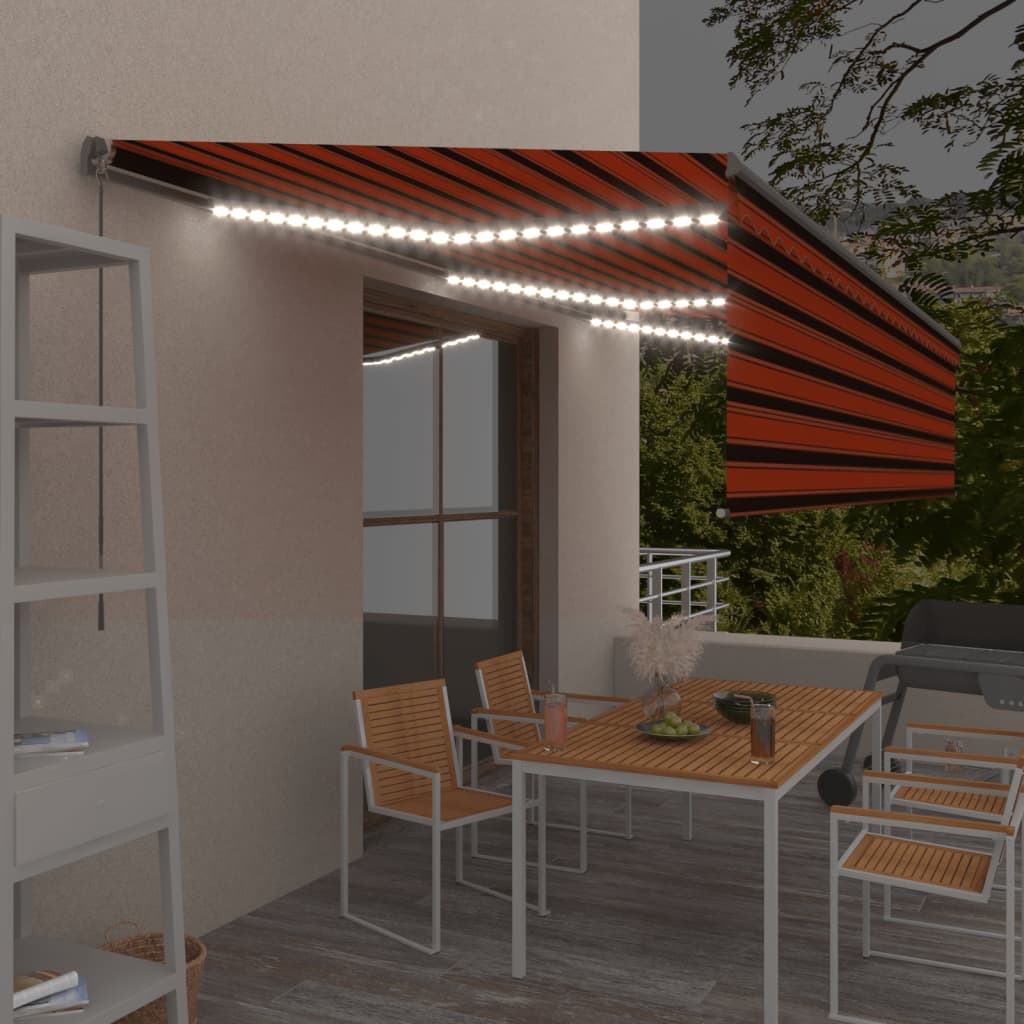 vidaXL Ročno zložljiva tenda s senčilom LED 6x3 m oranžna in rjava
